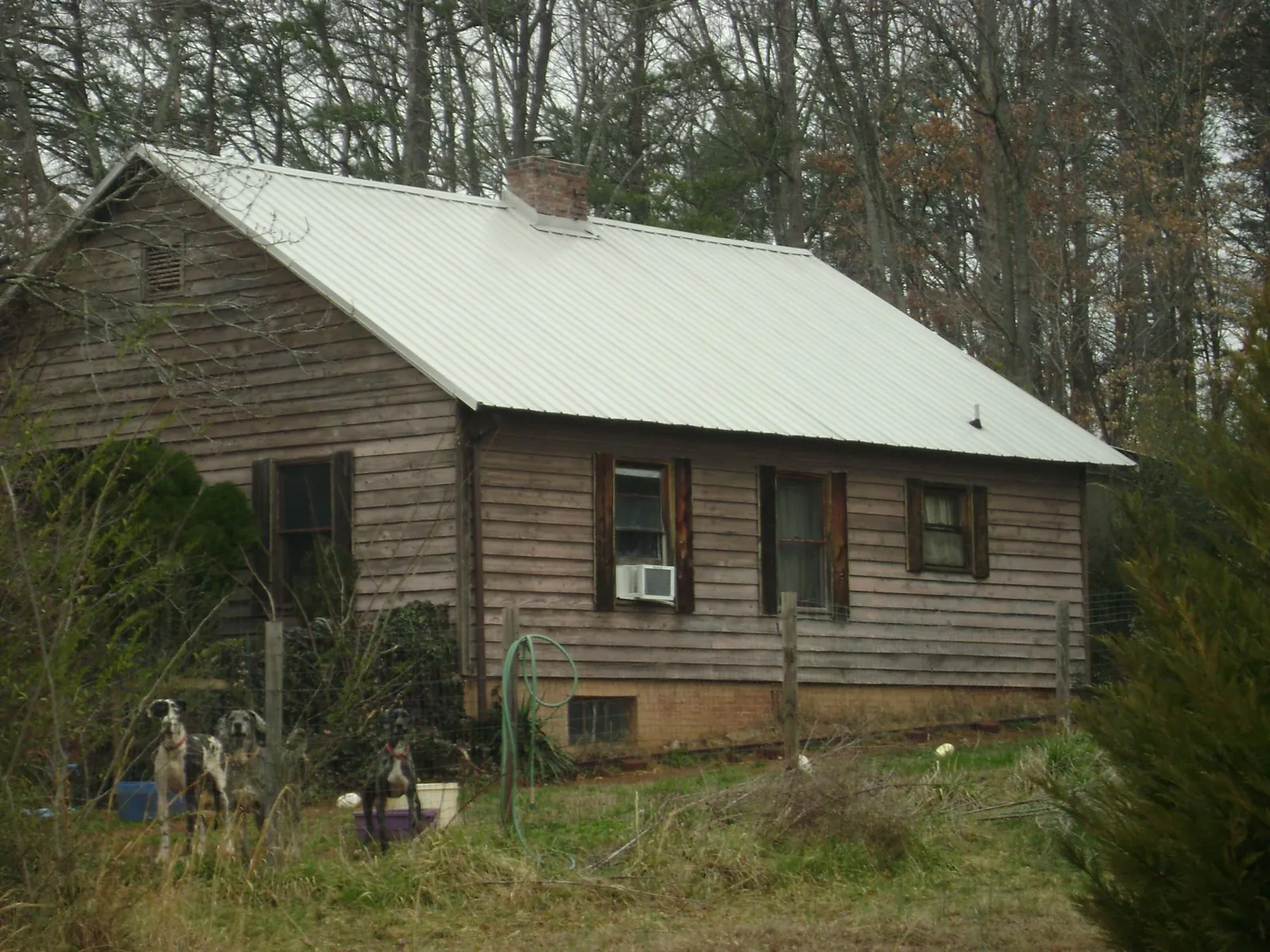 White metal roof on an old wood sided farmhouse, from a Asphalt Shingle Roof Repair job in Wellborn